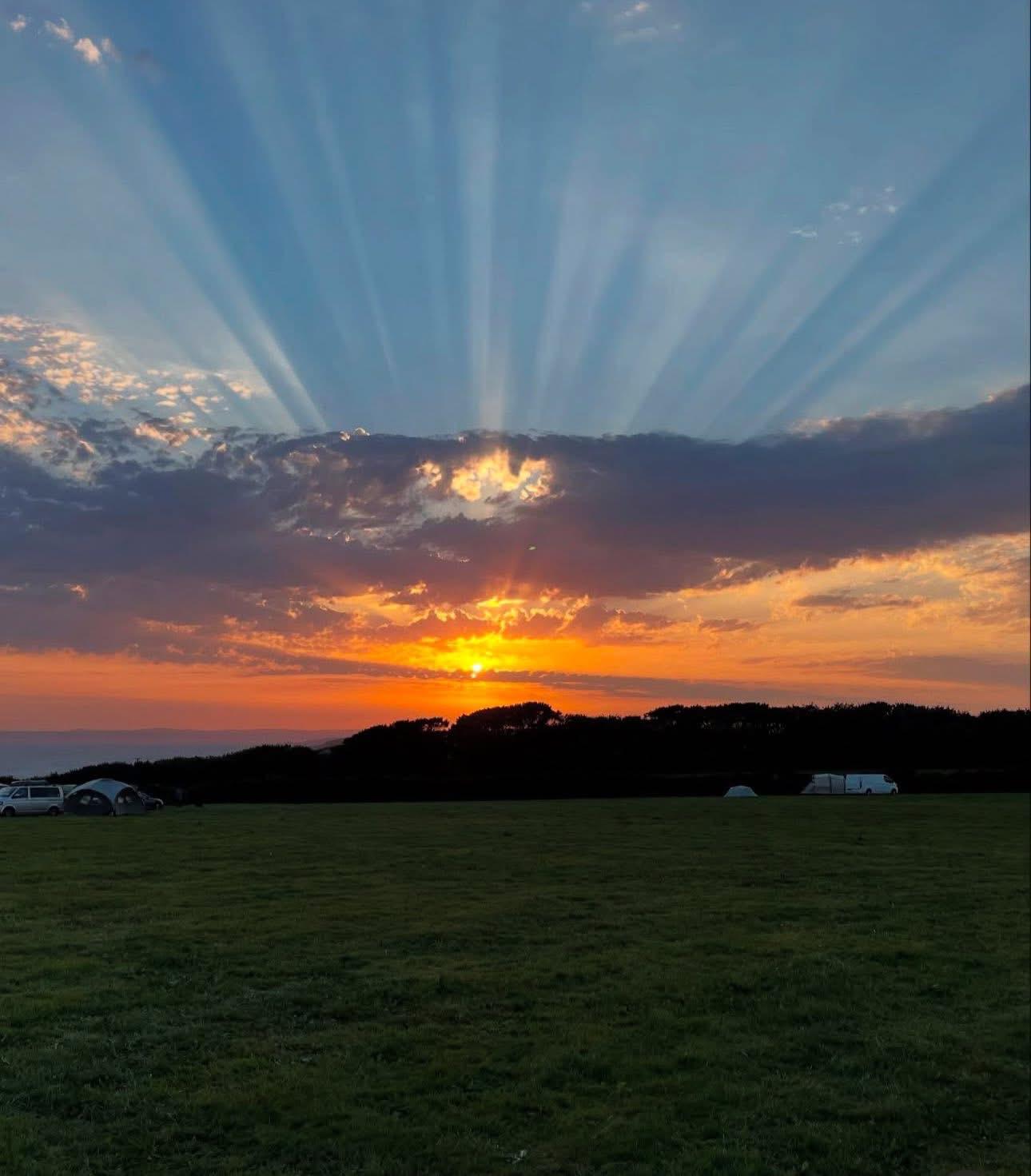 Sunset over the field at Penrose Camp Site